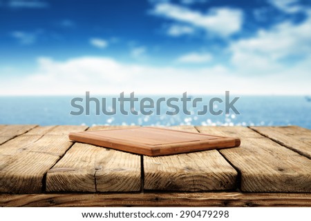 texture of blurred background of sea and sky and wooden table place and wooden desk space