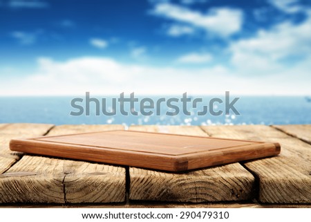 texture of blurred background of sea and sky and wooden desk space