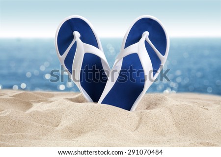 summer sand shoes of blue and sea on sand