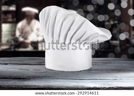 white cook hat and kitchen board