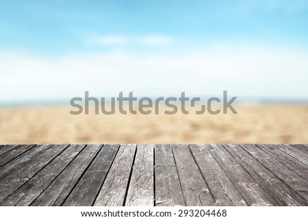 gray wooden pier space and beach with sand and sky