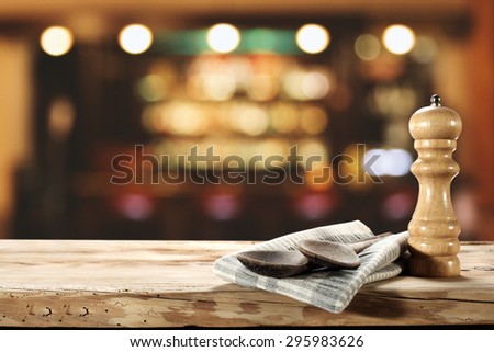 blurred background of bar and spoons on napkin