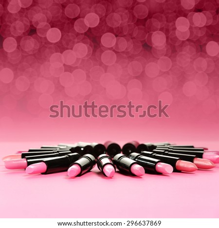 blurred background pink lights and black and pink lipsticks decoration