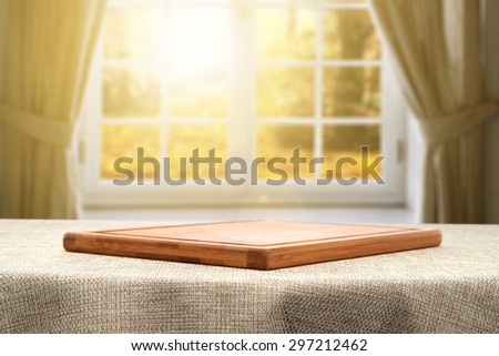 brown tablecloth window sun and empty wooden desk