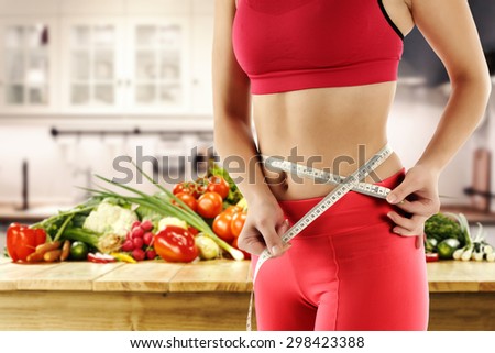 photo of slim woman and white kitchen
