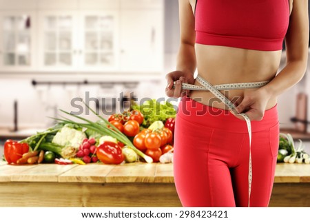 girl in kitchen and woman with fresh vegetables