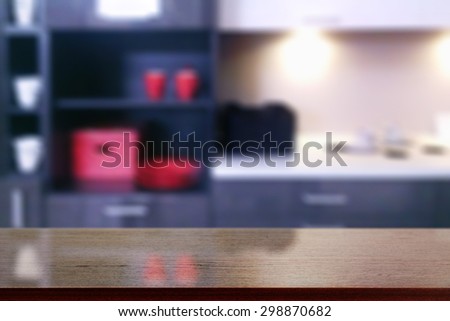 black desk space and blurred background of interior kitchen