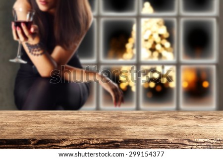 dark brown desk top woman with wine and window of winter time