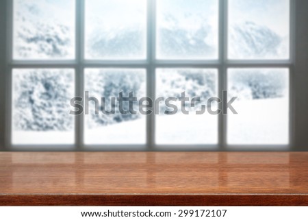 blurred background of winter window landscape and red desk space and free space for your food