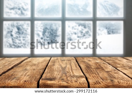 blurred background of winter window landscape and empty desk