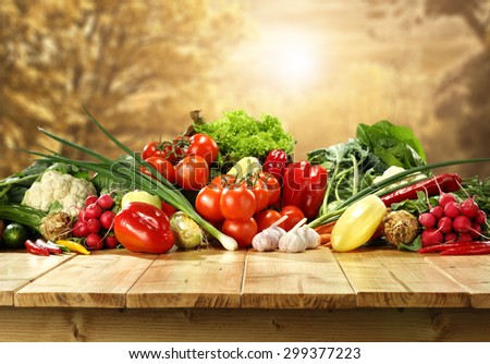 golden autumn background trees and few fresh vegetables on top of table