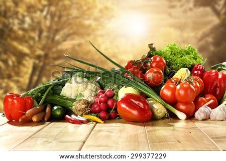 wooden board and sun light with decoration of healthy vegetables