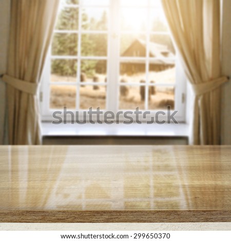 blurred background autumn windows with views to the farm and desk top of brown color and space for your decoration