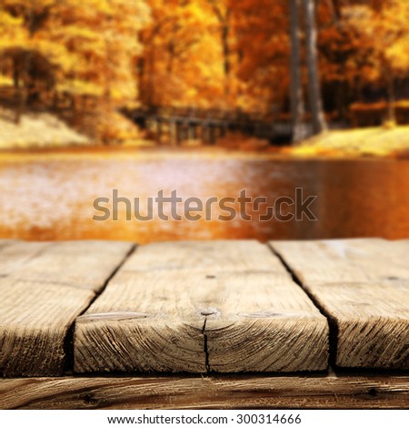 gray wooden desk space and golden autumn
