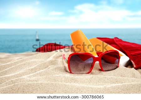 red sunglasses and red towel