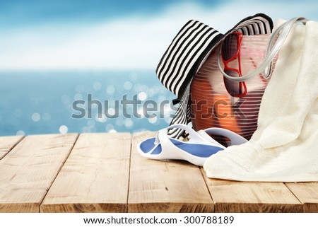 wooden table white and blue hat and white towel