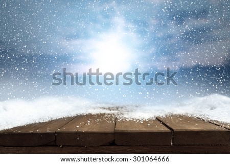 retro wooden table snow blue sky and ice with frost decoration in cold winter day