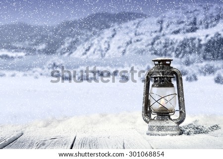 desk top of snow and lamp of blue color and space for you