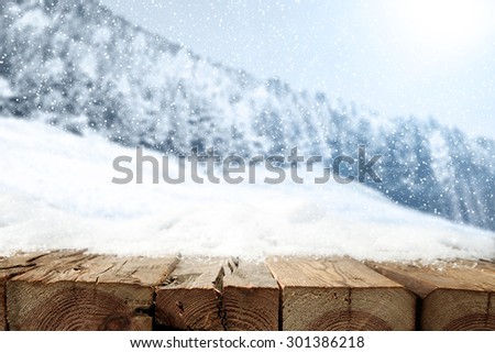 retro wooden table snow and ladnscape of winter forest