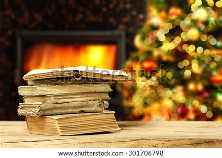 wooden desk in home books and one open and xmas tree