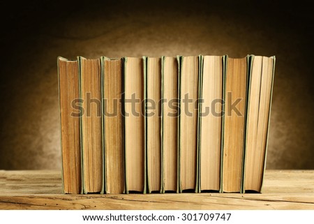 old books wall of bown color and wooden desk top