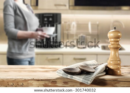 spoons in kitchen and woman