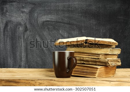 brown mug of tea and books