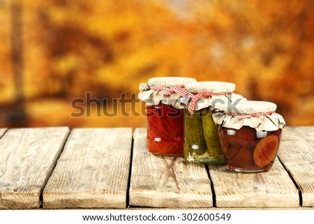 three jars on table and autumn space