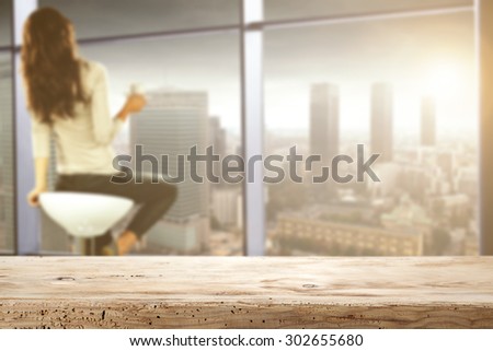 wooden desk top of space for you and woman with window