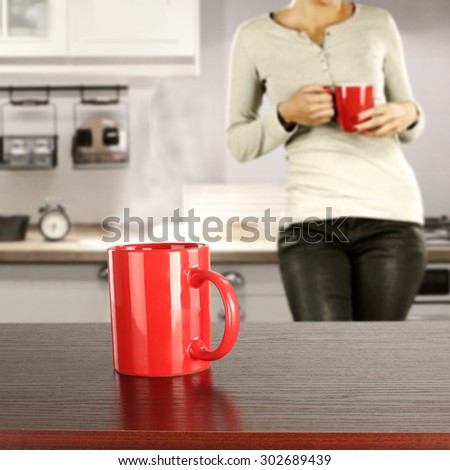 red mug of drink on brown desk space
