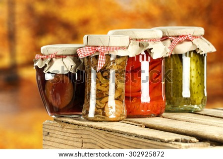 wooden box background and autumn jars of food space