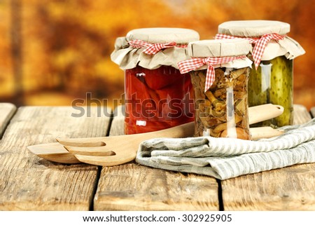 three glasses jars on table napkin of brown color and fork of wood