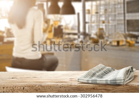 blurred background of bar with woman on chair and desk and napkin