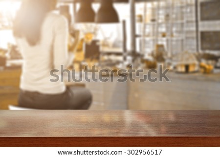 blurred background of bar with woman on chair and cafe board