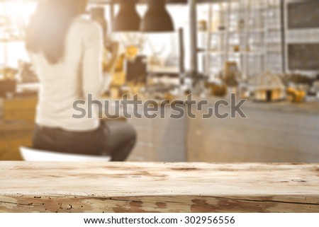 blurred background of bar with woman on chair and dirty worn board