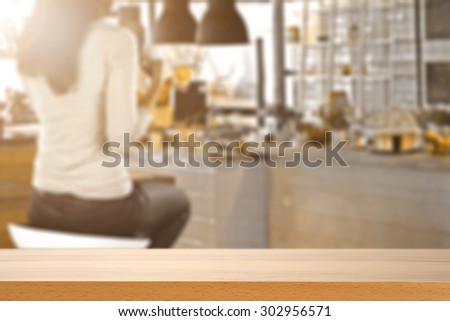 blurred background of bar with woman on chair and board for you and sun