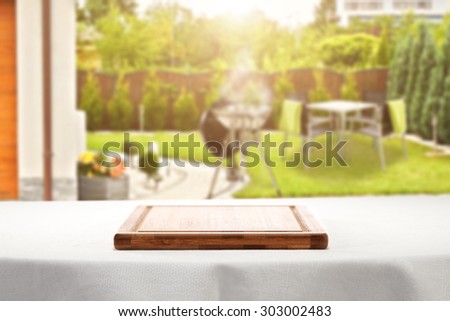 desk of wood white tablecloth and english garden space