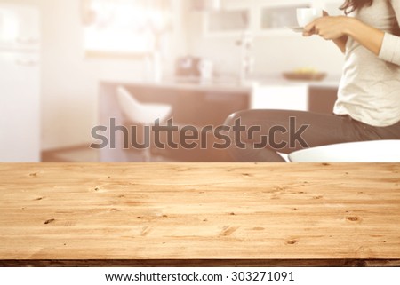 wooden board in kitchen and woman with coffee