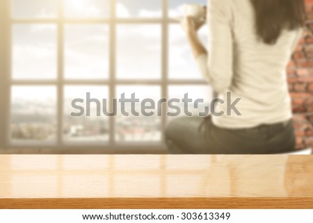 blurred background of wall of red color and white window and chair and woman