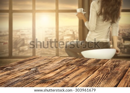 woman with coffee cup and desk top of retro chair