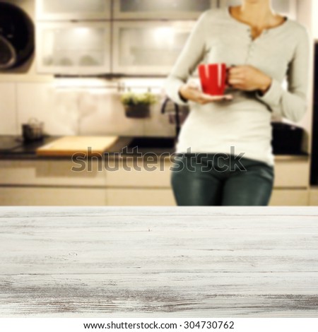 white desk in kitchen and woman with red mug
