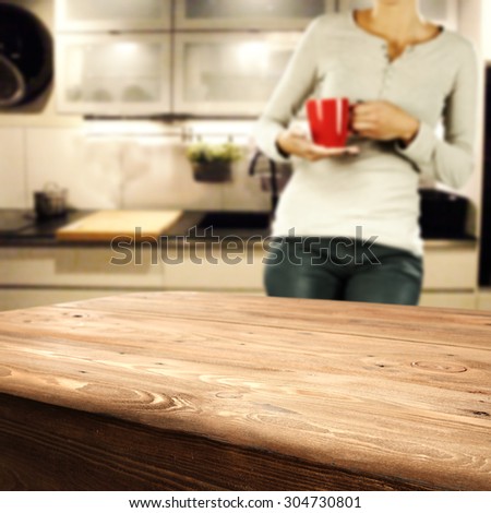 big table woman with red mug and kitchen interior space