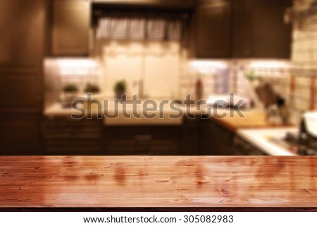 blurred background of red kitchen interior and red desk top and empty space for you