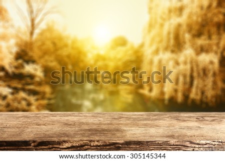 brown retro wooden desk top and autum space and sun light