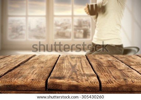 big borown table place and woman on chair with brown mug