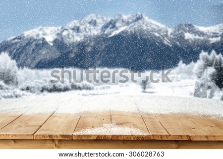 blurred landscape of mountains and snow on wooden table place