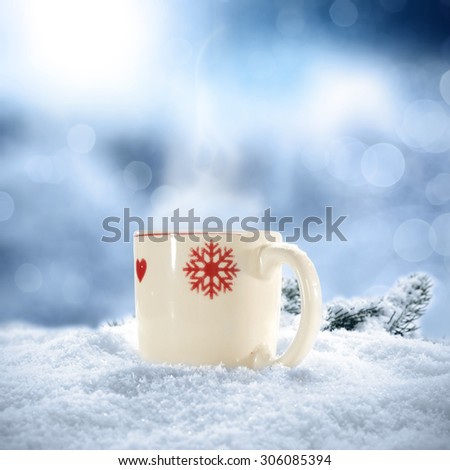 blurred background of winter frost and blue snow and mug