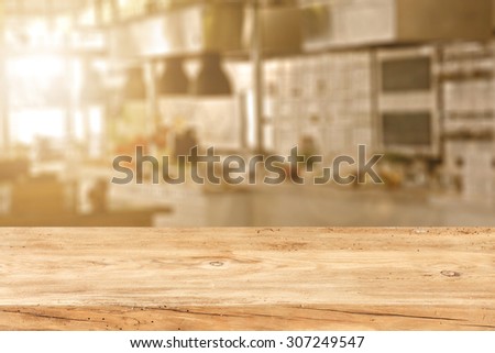 blurred background of kitchen of sun light and retro wooden kitchen desk