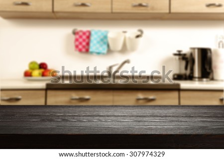 blurred background of kitchen interior and black desk of wood