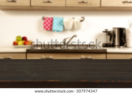 blurred background of kitchen interior and dark board space of wood